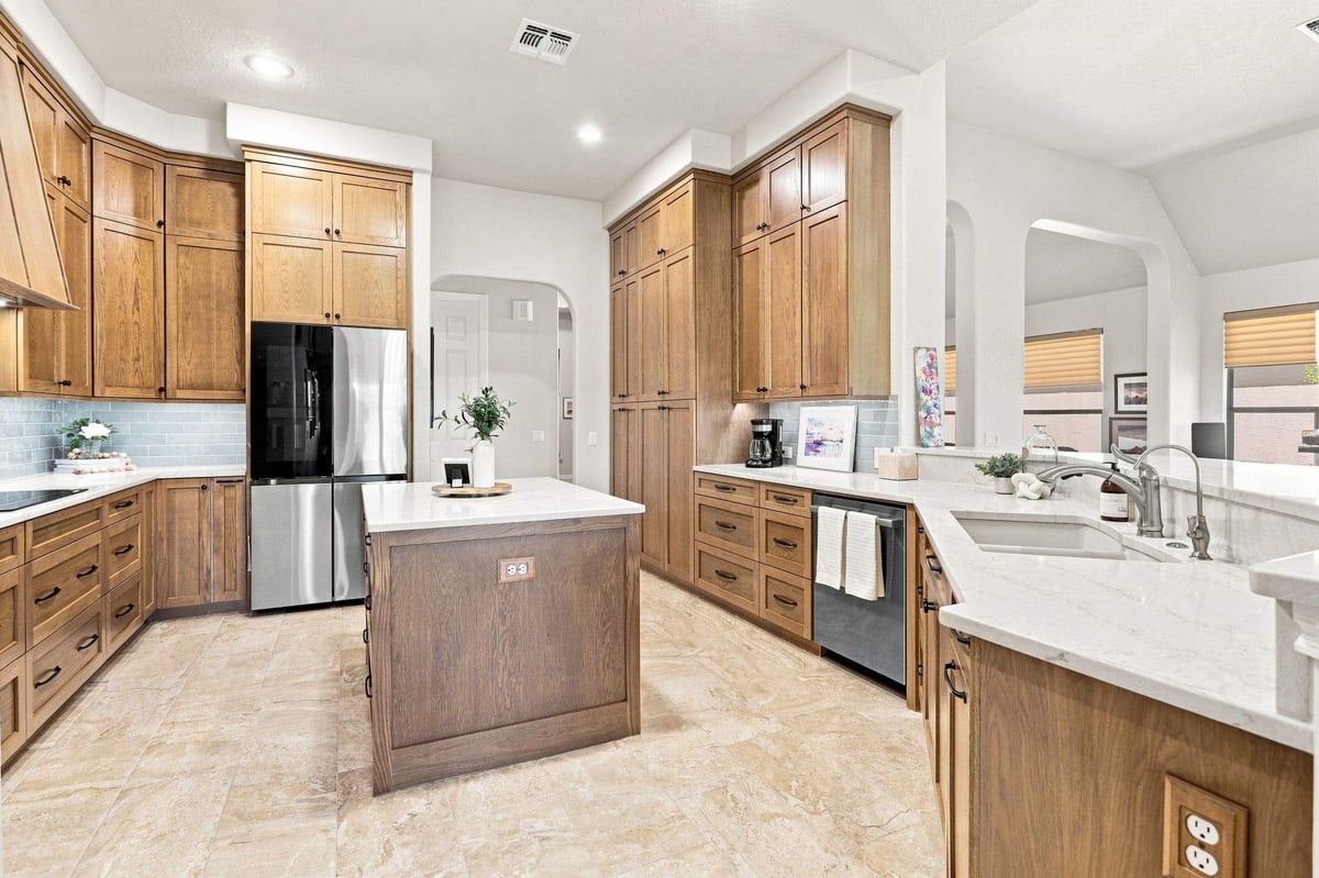 San Antonio kitchen remodel in Roseheart featuring warm wood and sage green backsplash with island.
