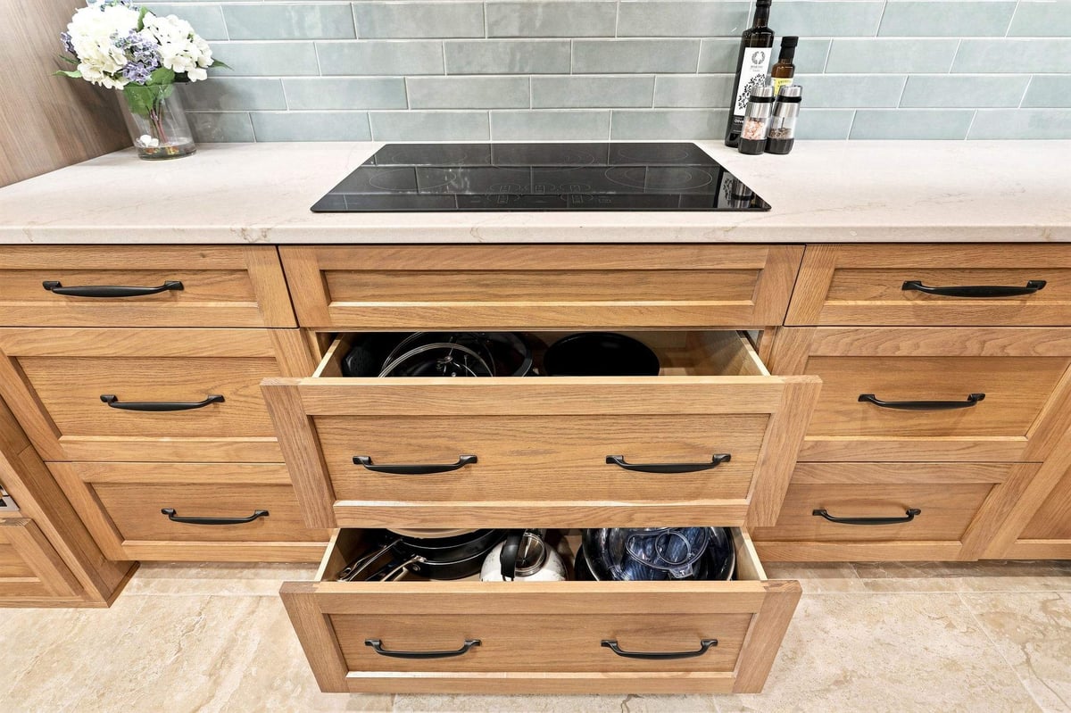 Deep drawers beneath the kitchen cooktop providing convenient storage for pots and pans.