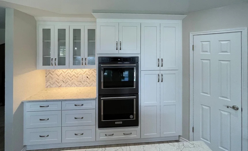 White Cabinets in Kitchen Remodel with Build in Double Ovens and Under Cabinet Task Lighting
