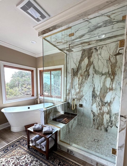 Bathroom with standalone tub and marble shower