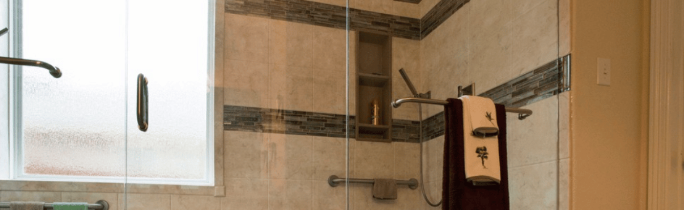 Walk-in shower with tan and gray tile