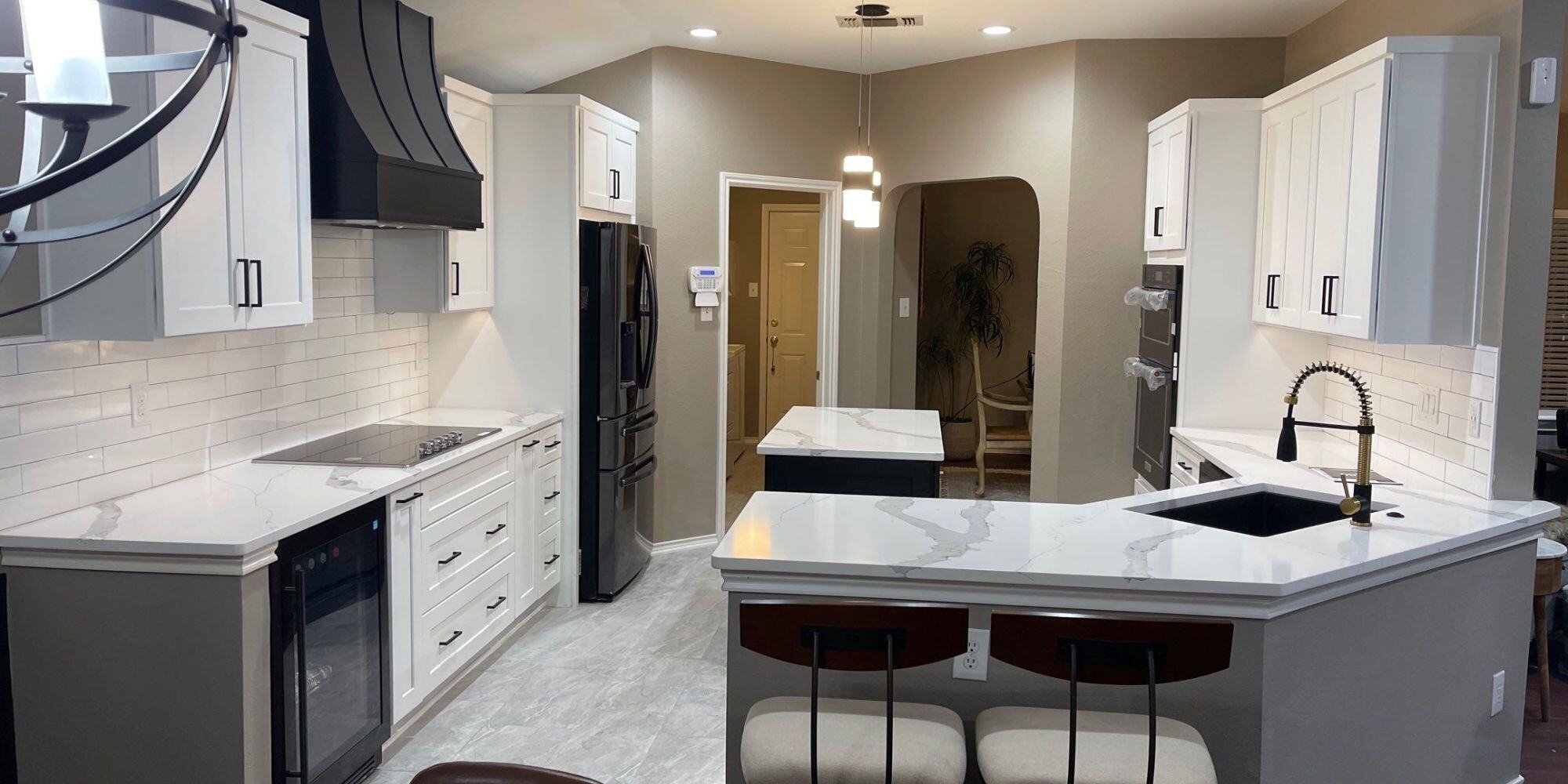 black and white kitchen remodel in san antonio with island and custom lighting