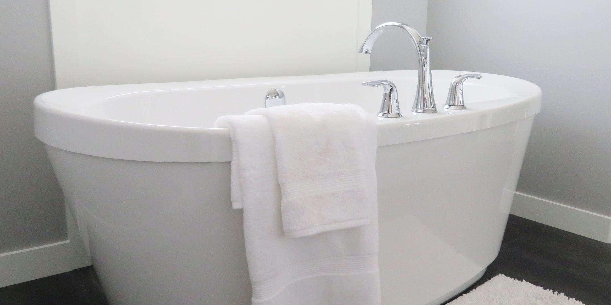 freestanding bathtub in a minimalist black and white bathroom