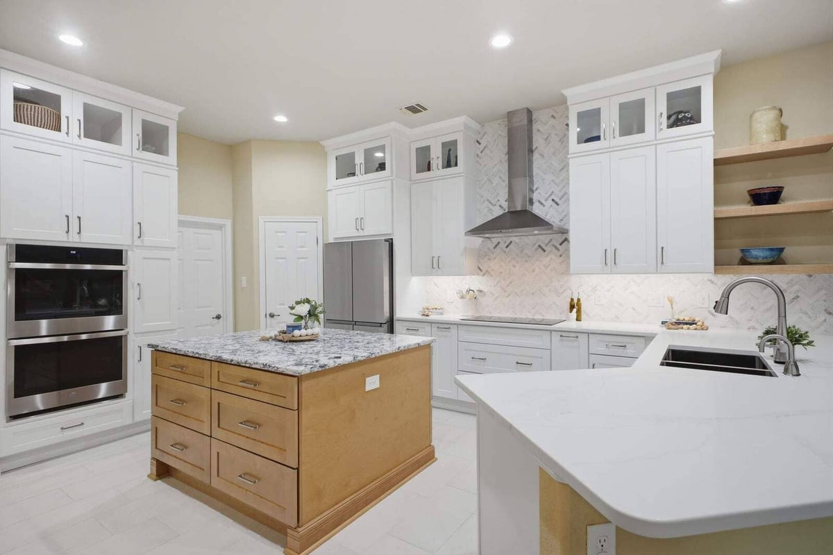 Bright Deerfield kitchen remodel with white cabinets, wood island, stainless appliances, and double ovens.