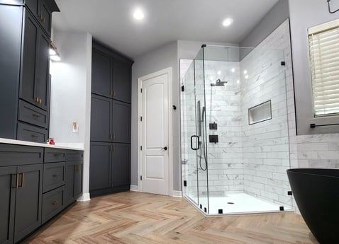 Bathroom with dark navy cabinets and a walk-in shower