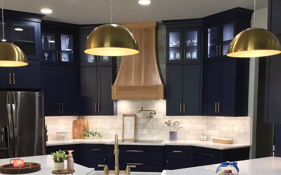 Kitchen with navy blue cabinets and gold finishes