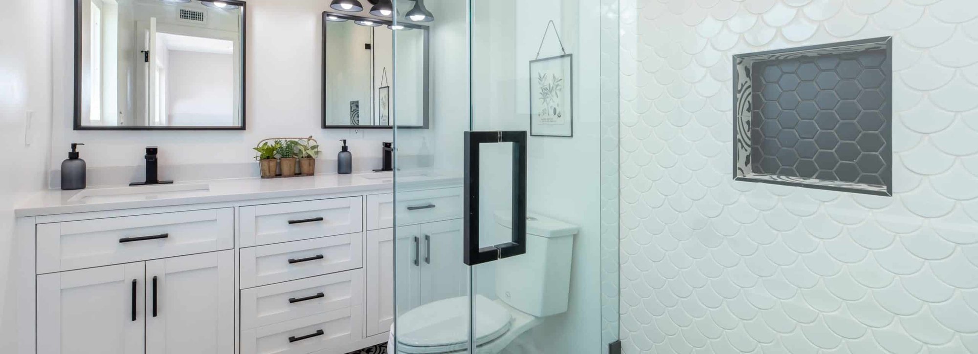 Bathroom with white counter tops and cabinets with a walk-in shower