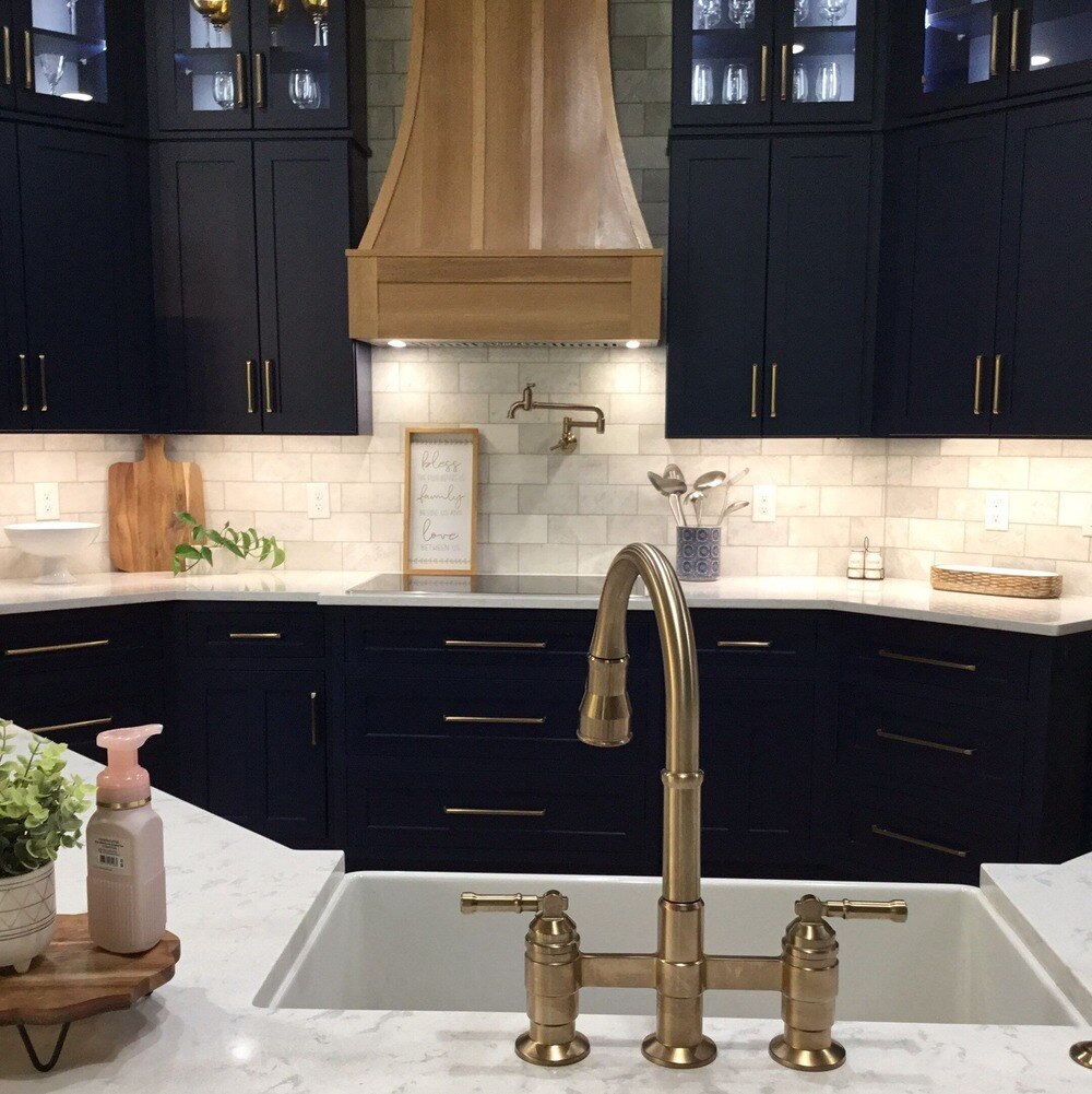 Kitchen with blue cabinets and gold hardware