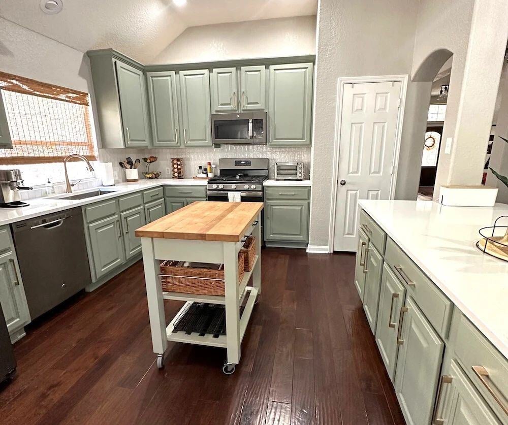 green kitchen remodel with butchers block and white counters