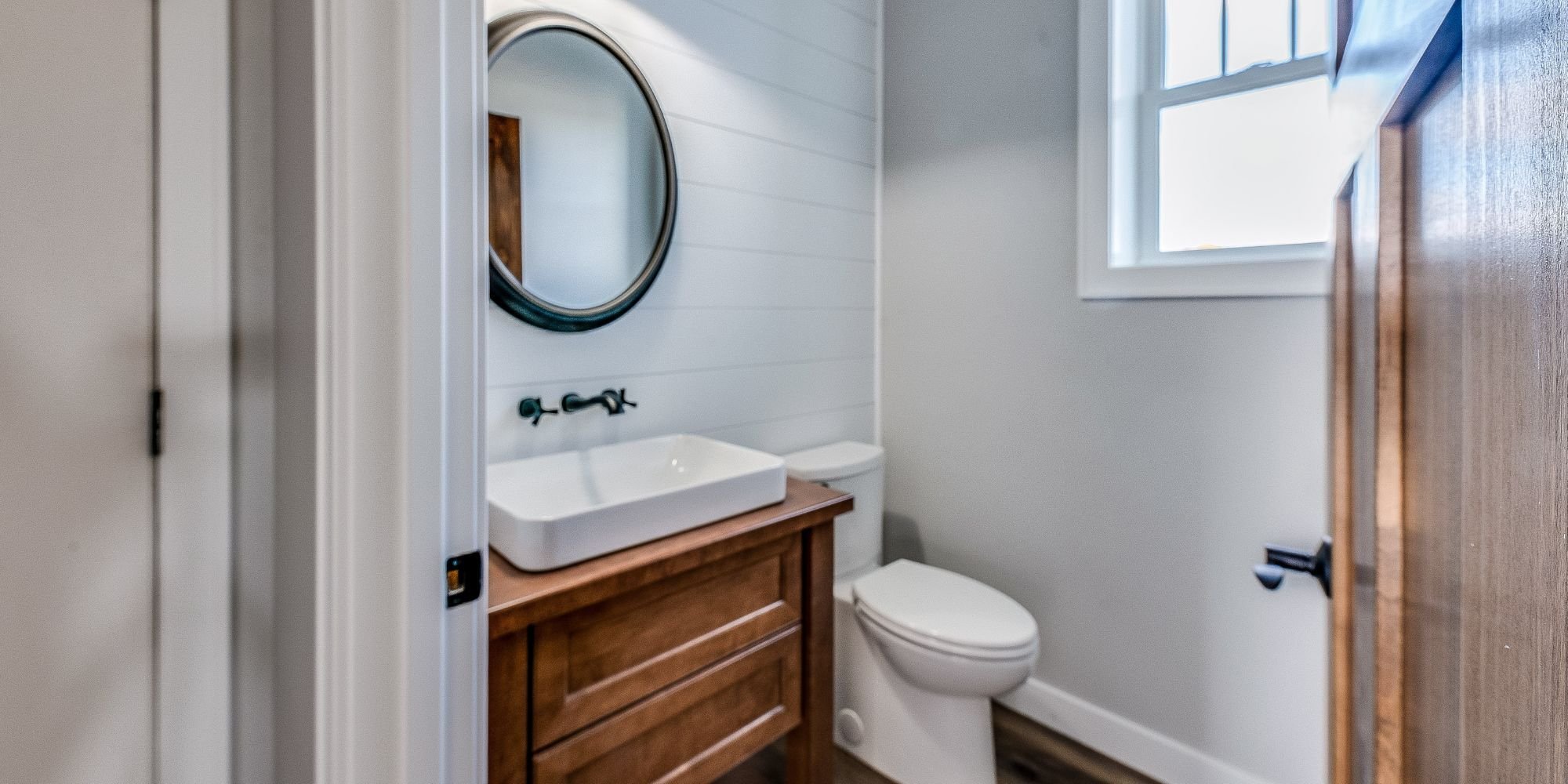 half bathroom renovation in san antonio with shiplap walls and wood vanity