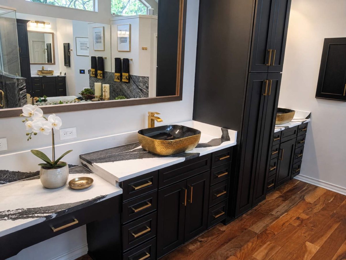 Black vanity with gold hammered vessel sink and matching linen tower