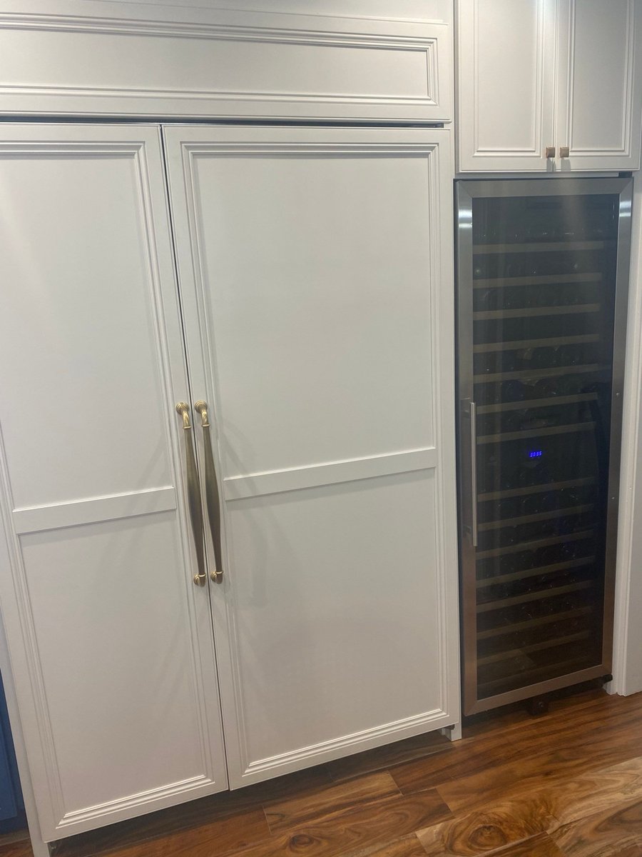Gas cooktop and quartz counter beside colorful animal tile backsplash