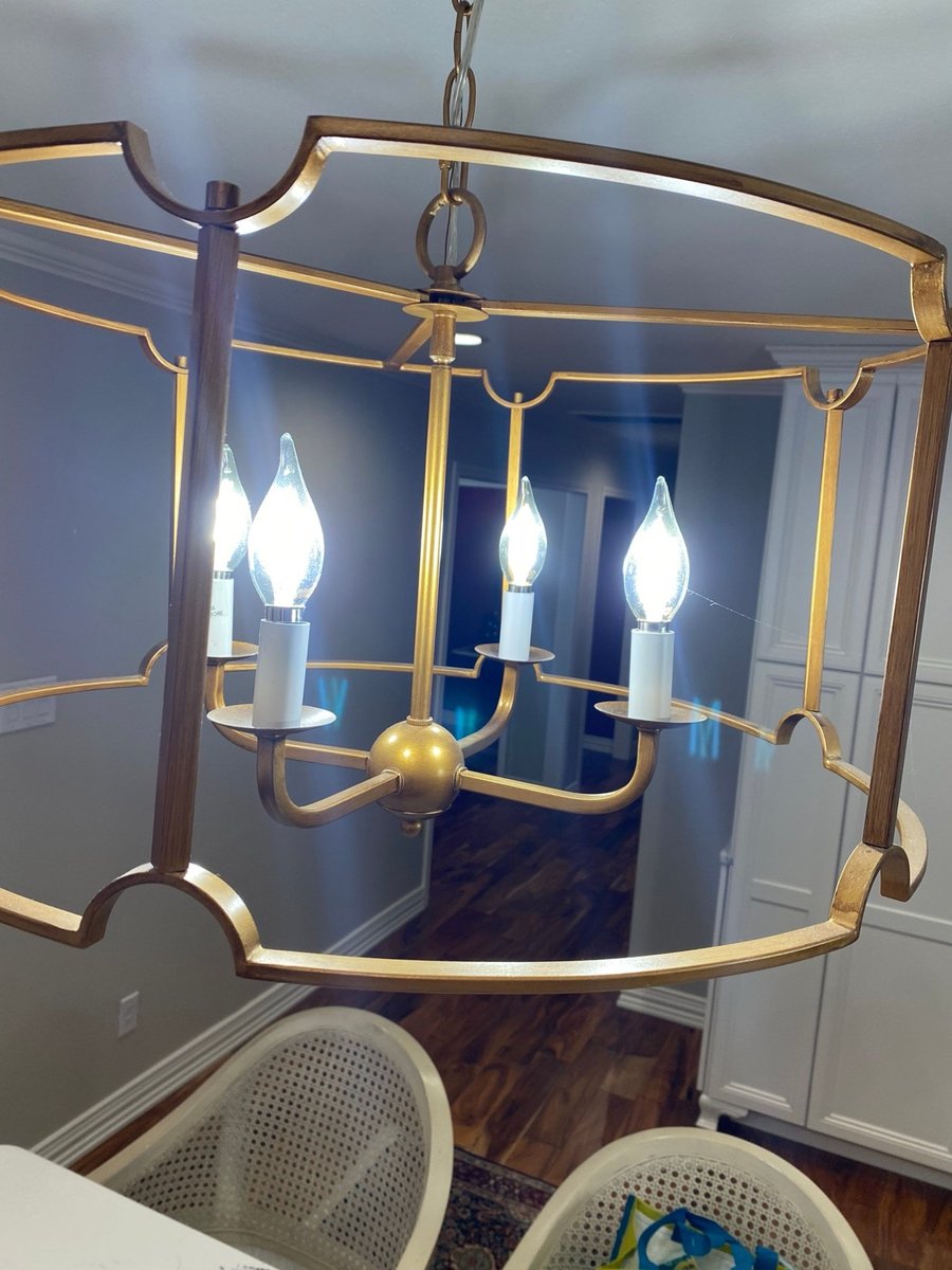 Navy U-shaped kitchen with quartz island, brass lights and wine fridge