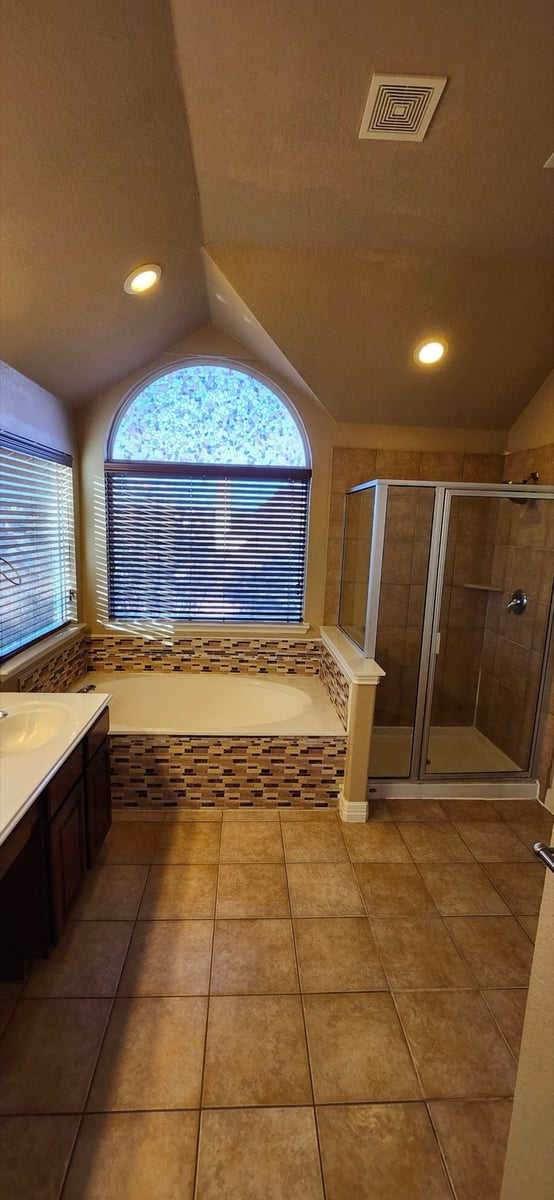 Original master bath with beige tile, drop-in tub, mosaic accent, and dated shower before remodel