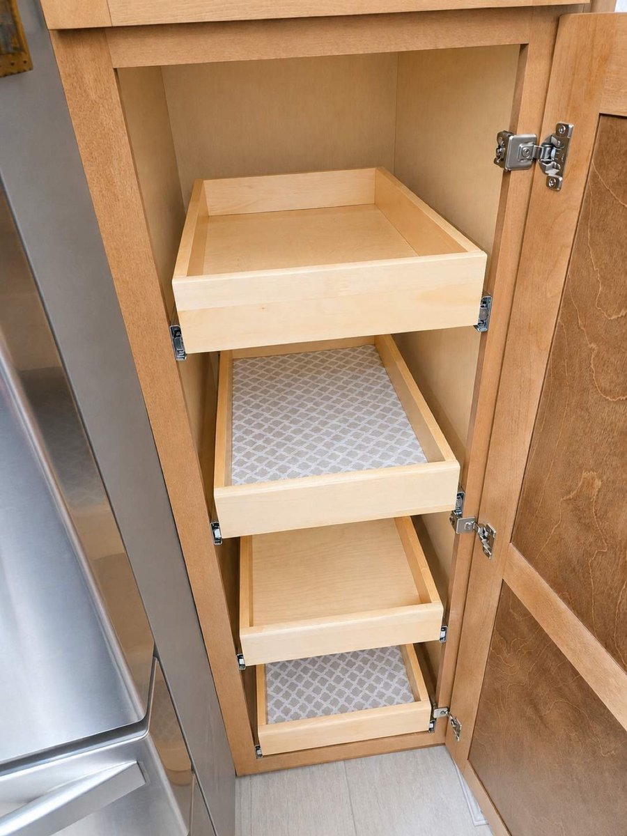 Tall cabinet with three wood roll-out shelves beside refrigerator