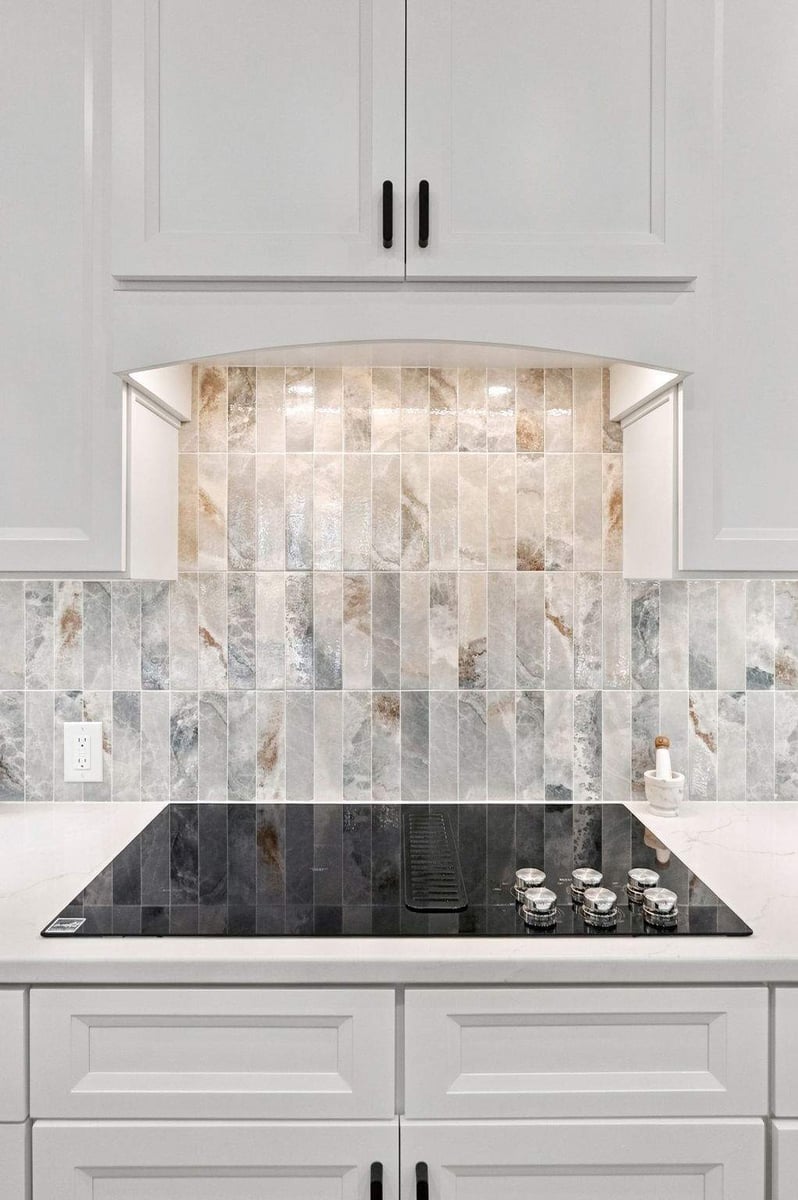 Cooktop and white range hood in a Cibolo Canyons kitchen remodel in San Antonio.