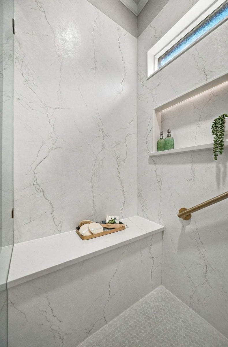 Close-up of marble-look wall panels in a San Antonio walk-in shower remodel, highlighting the elegant stone-inspired finish.