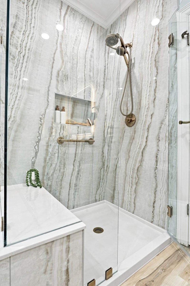 Walk-in shower featuring dramatic natural stone walls and a frameless glass enclosure.