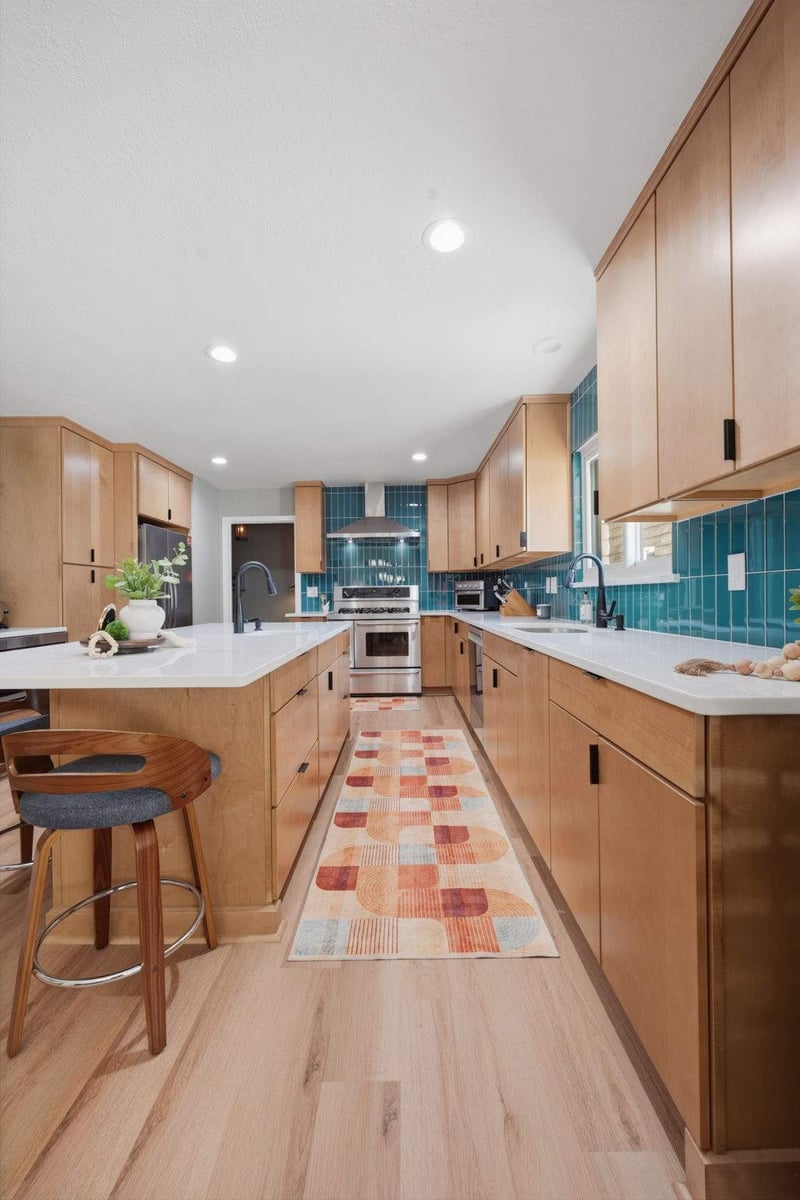 Castle Hills kitchen with natural wood cabinetry and bold teal tile backsplash