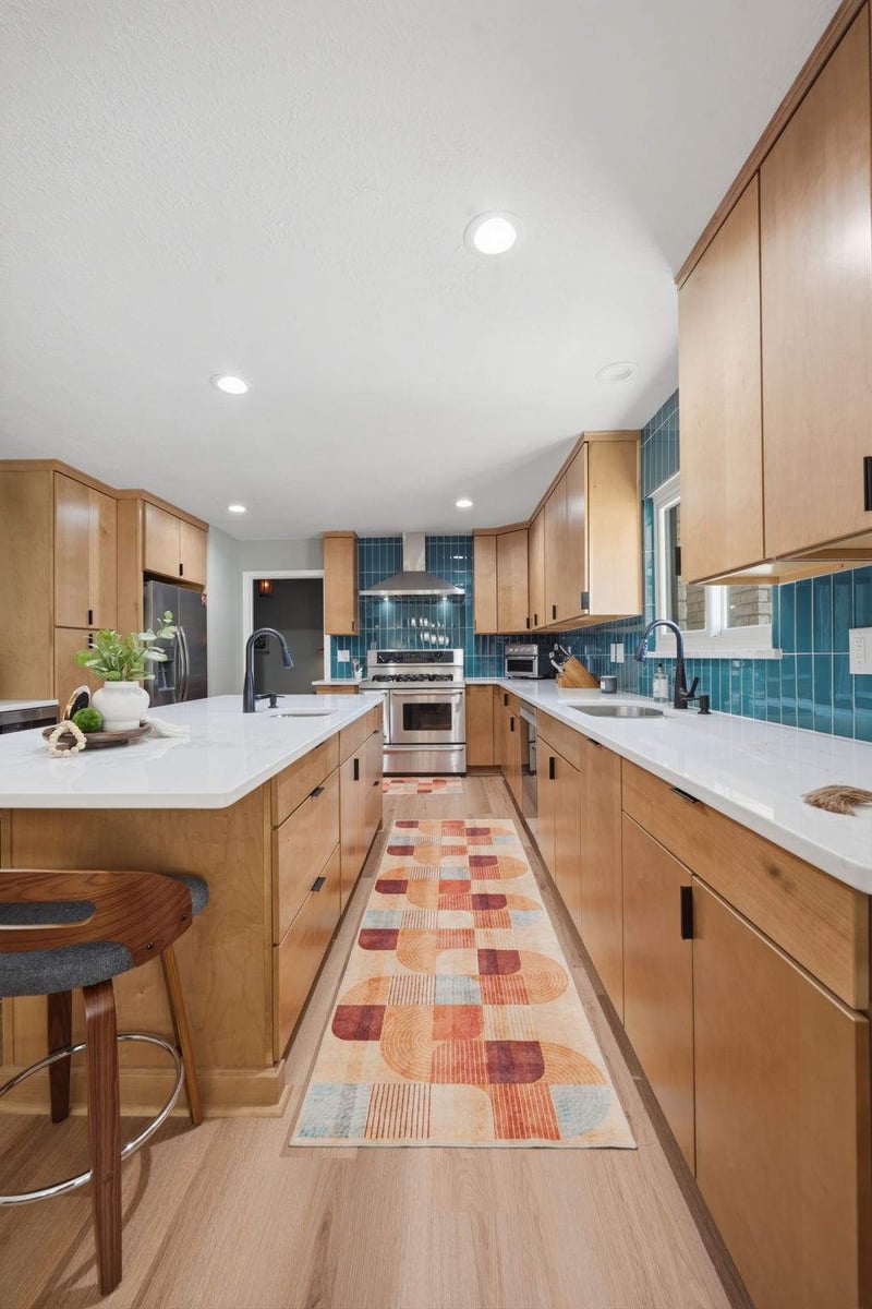 Full view of Castle Hills kitchen remodel with teal tile and wood cabinetry
