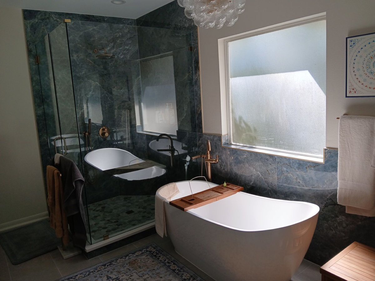 Master bath with green marble shower, freestanding tub, and frosted window