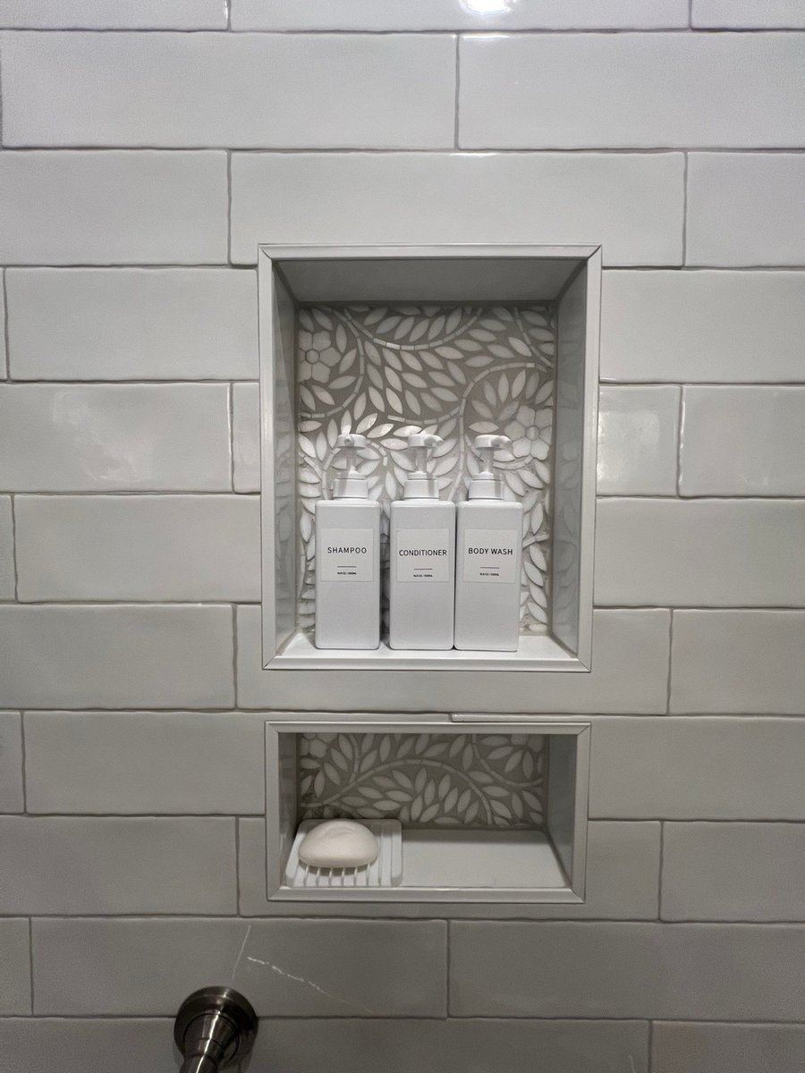 Double vanity with wood cabinets, tower cabinet and checkered marble floor