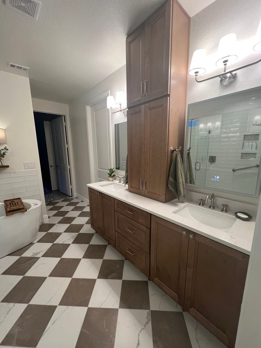 Wood double vanity with two undermount sinks and central storage tower