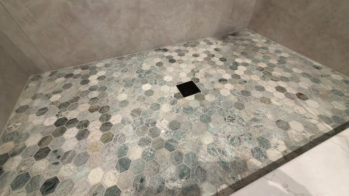 Green and gray hexagon mosaic shower floor with square black drain