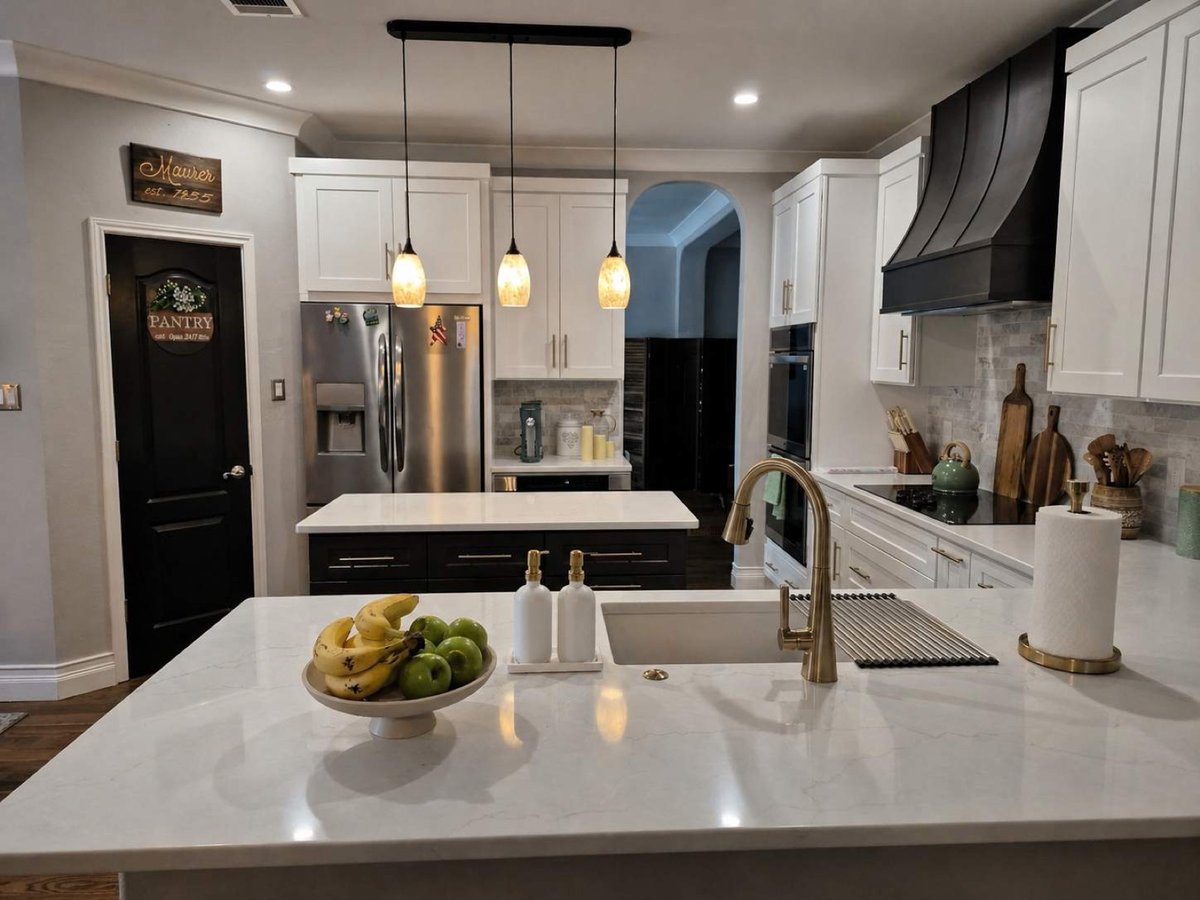 White pull-out drawers inside cabinet beside stainless refrigerator