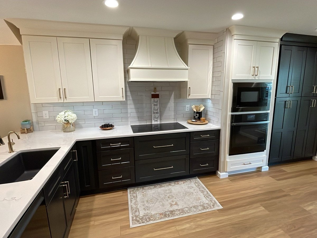 Close-up of veined white quartz counter with brushed nickel faucet and pot filler