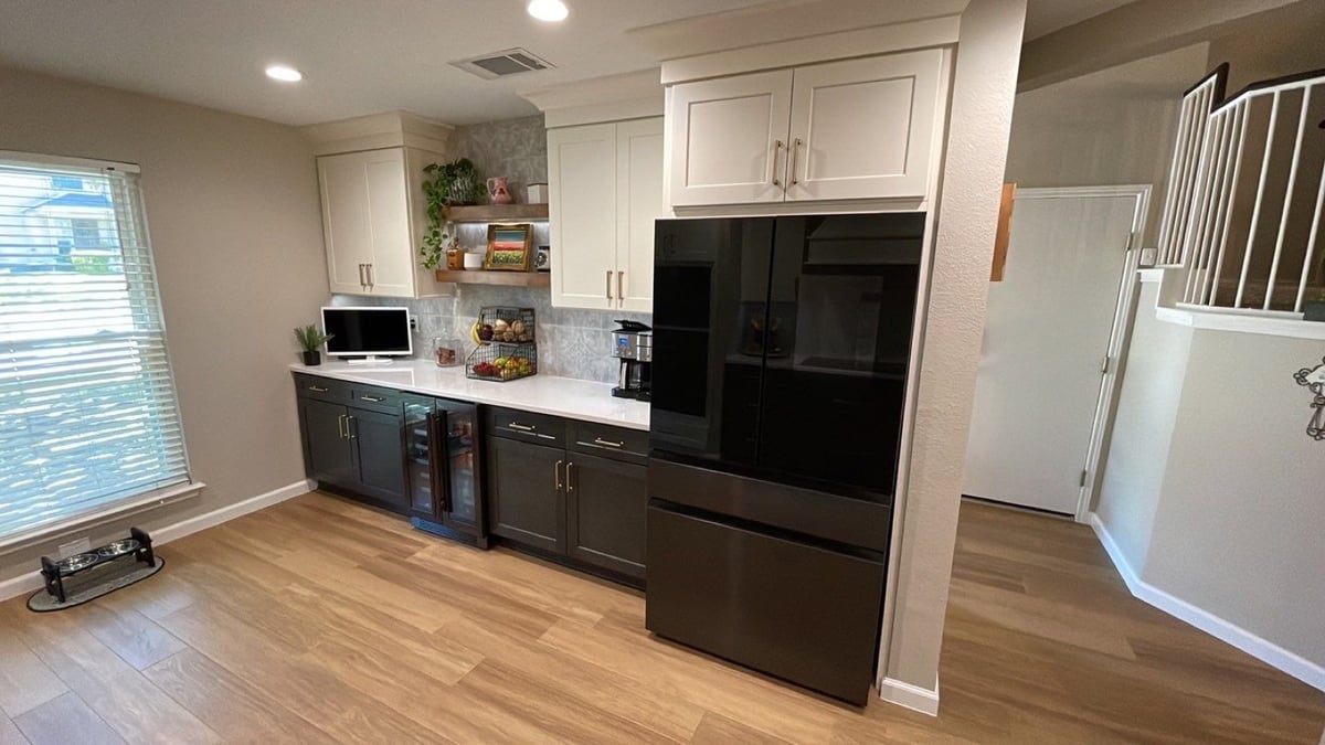 Beverage station with cream and dark cabinets, wine fridge and decor shelf