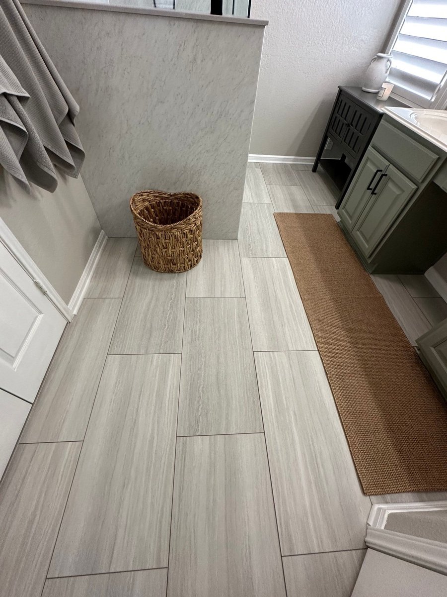 New wood-look tile floor with knee wall, green vanity, and woven basket