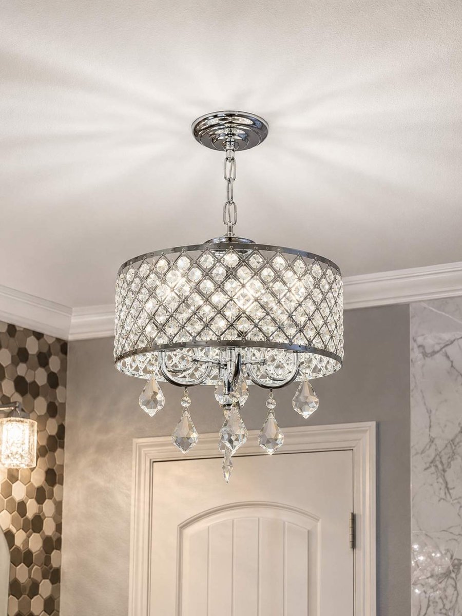 Chrome crystal drum chandelier mounted on ceiling above white arched door