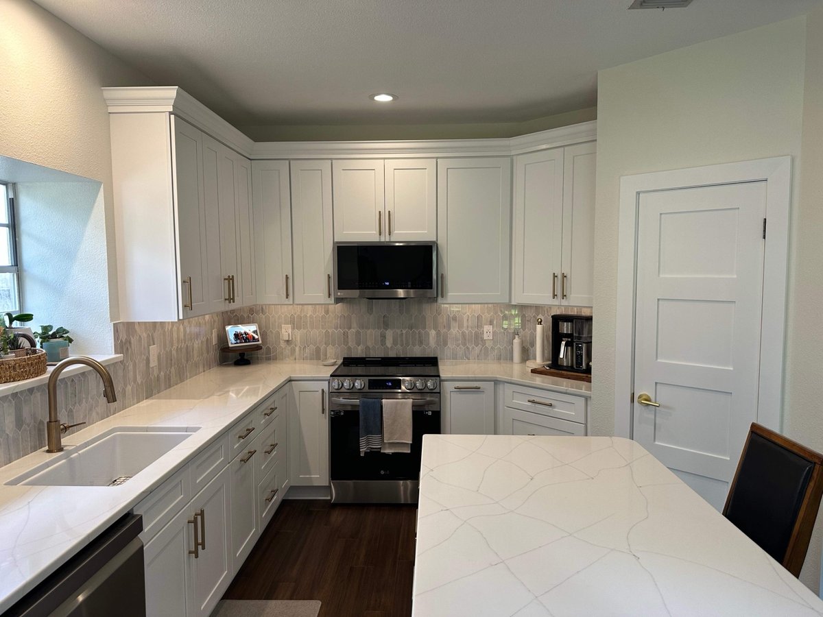 White shaker cabinets and quartz counters with picket-tile backsplash