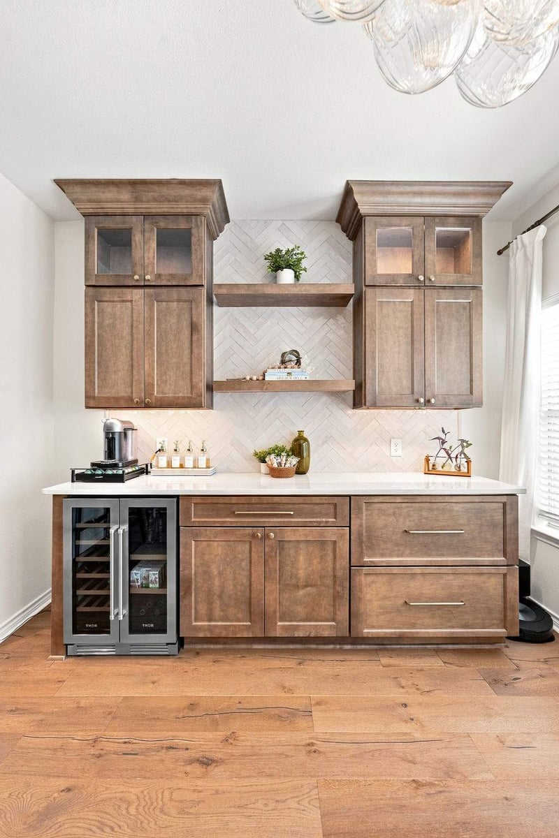 Custom dining area beverage bar with warm wood cabinets, floating shelves, tile backsplash, and built-in beverage refrigerator.