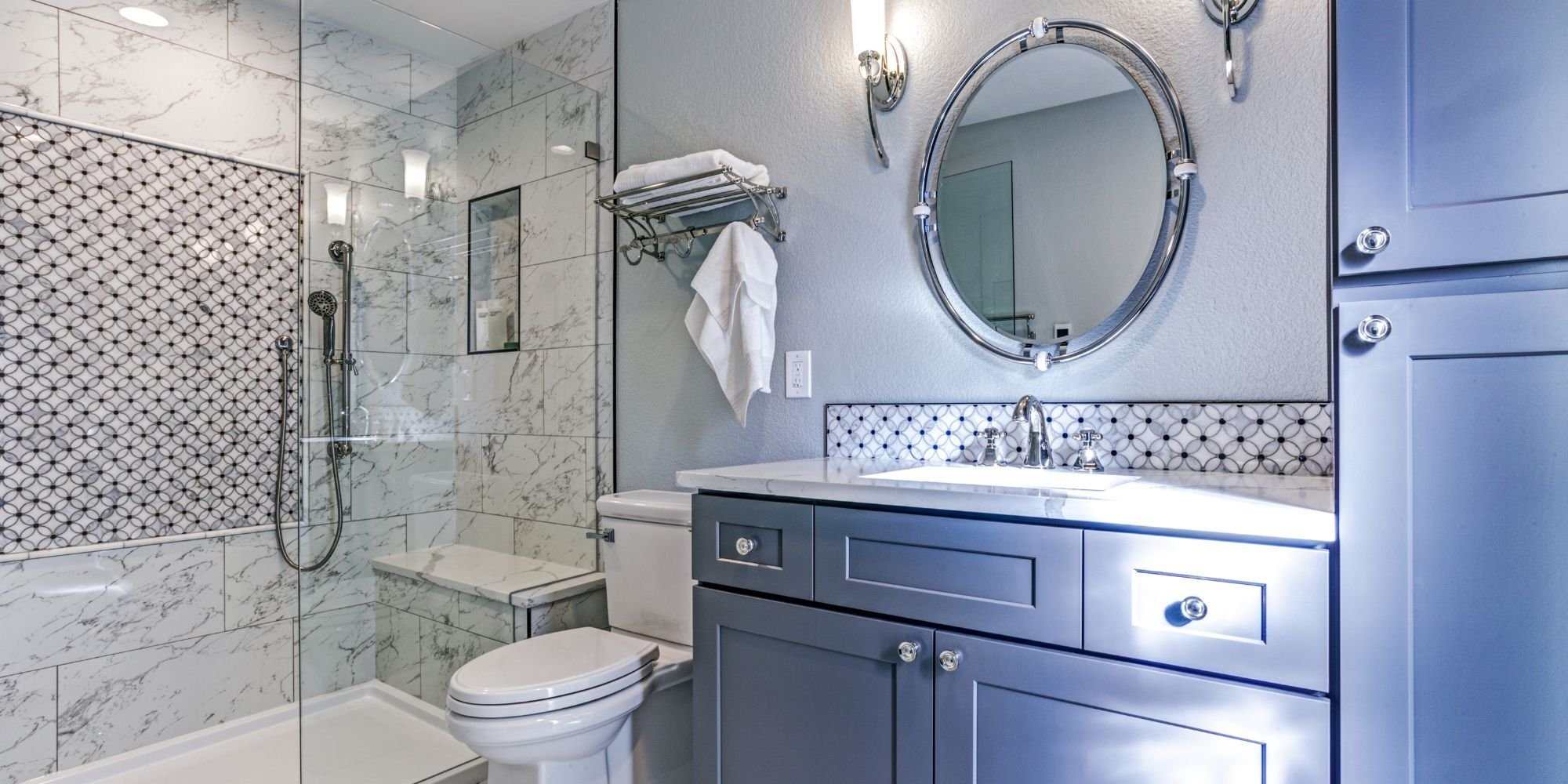morrocan tile and marble walk in shower in a san antonio tx bathroom remodel with blue cabinets