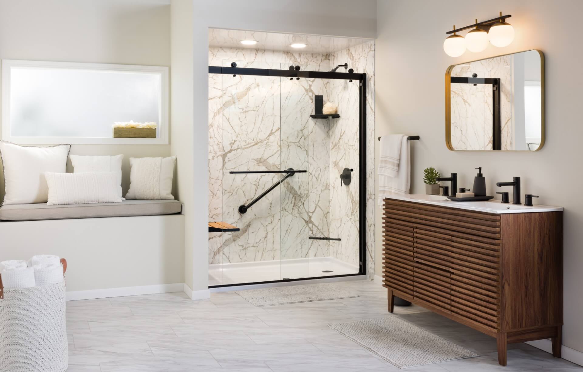 Modern bathroom with sleek marble walls and a glass-enclosed shower featuring matte black hardware.