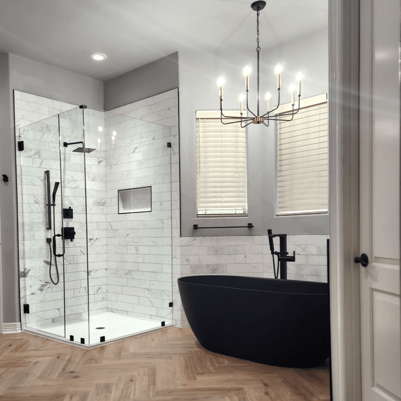 San Antonio bathroom with white tile shower and black bathtub