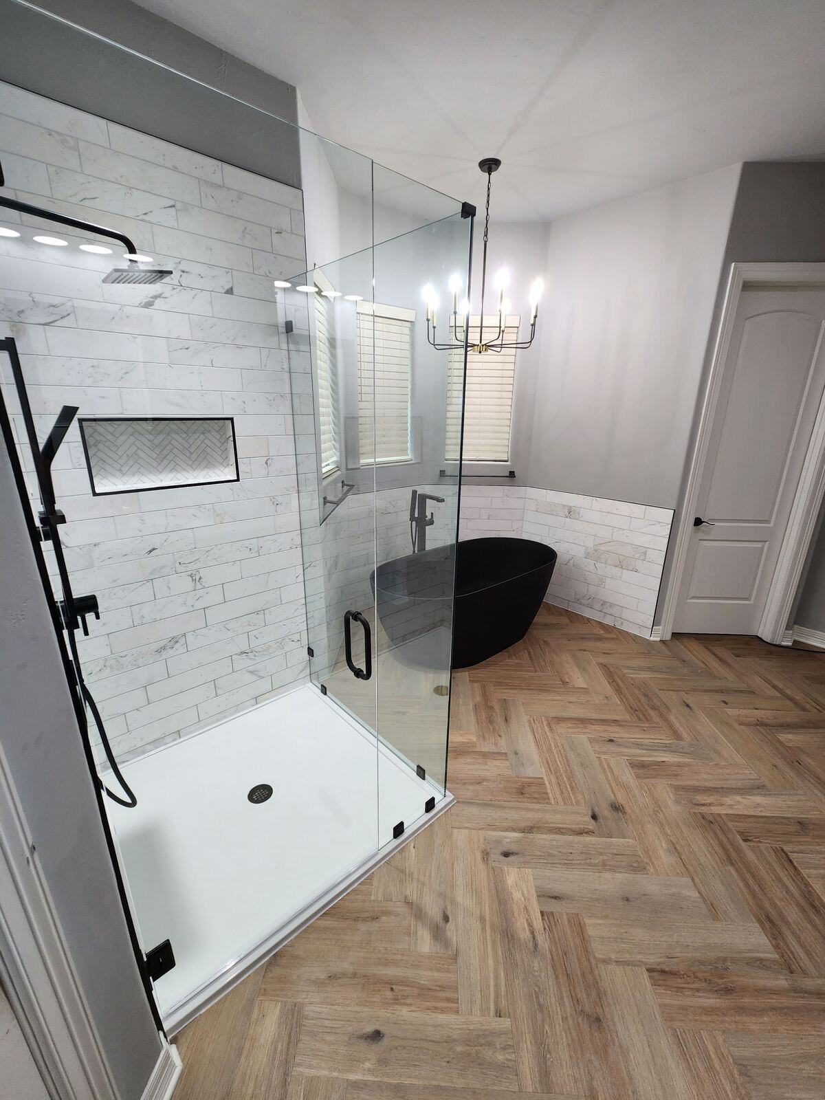 Modern bathroom remodel with glass shower and black bathtub by Legacy Kitchen & Bath in San Antonio