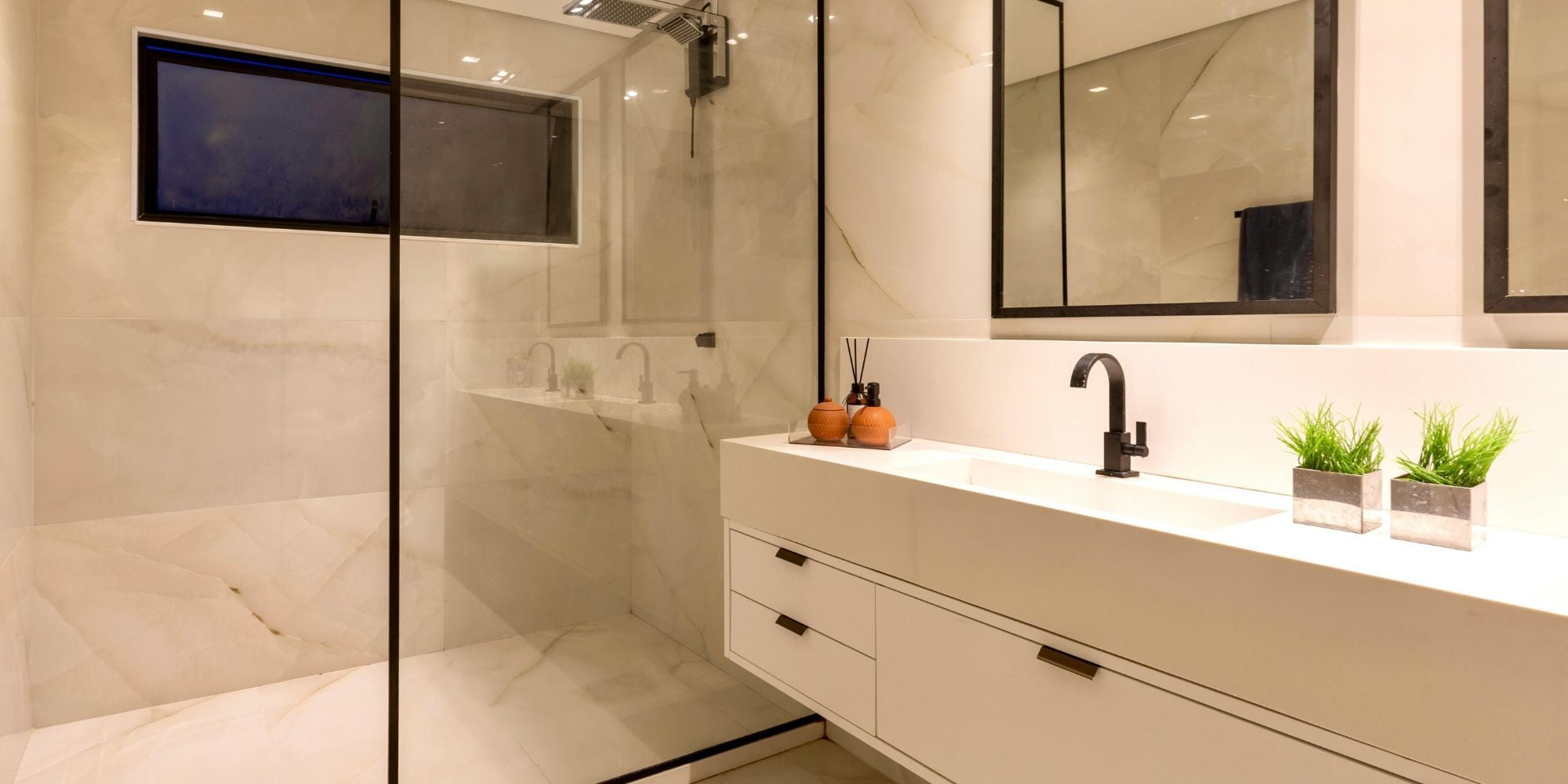 Neutral bathroom renovation in San Antonio with walk in shower and floating vanity